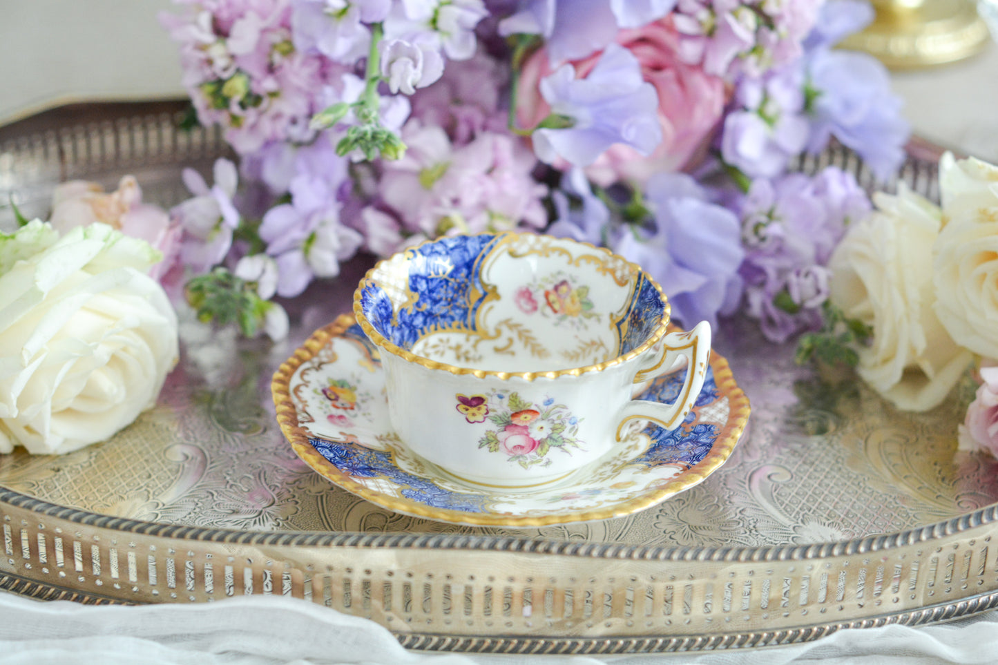 コールポートの人気シリーズ、バットウィングシリーズ。とても珍しい模様のデュオが入荷しました。鮮やかなブルーカラーの年輪のような模様がとても美しいお品です。カップのサイドにはエナメルのお花たちが描かれています。以前色違いの淡いグリーンをご紹介したことがあります。こちらは、カップに製造時にできたと思われる小さな穴があります。貫通はしていないのですが、そこだけ油薬がかかっていません。その穴付近にごく微細な貫入が1つあります。 その他は貫入もなく、金彩もとても綺麗に残っていて、キラキラと輝いています。特別なバットウィング。プレゼントにもご自身のご褒美にもぴったりなお品です。