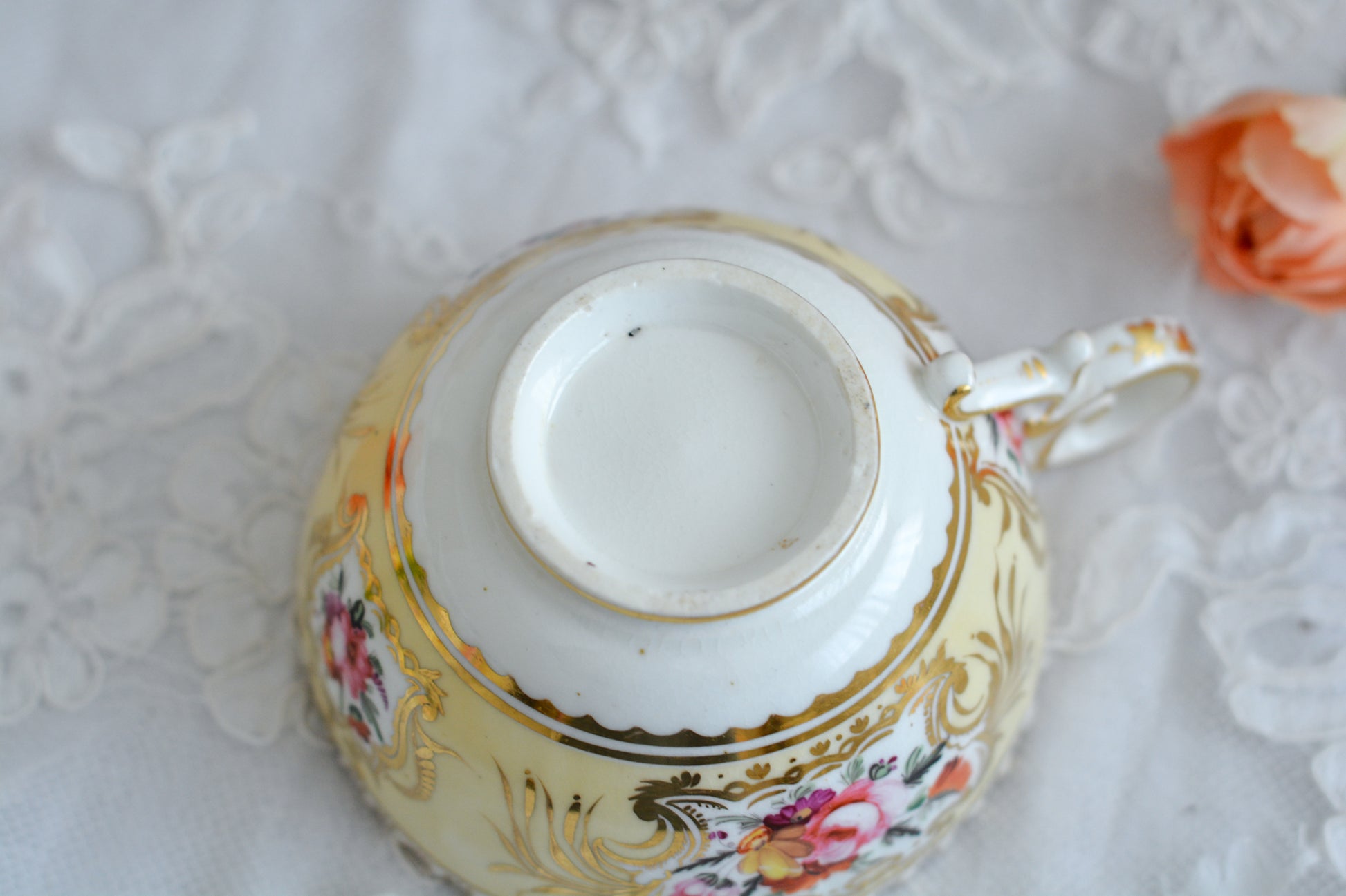 コールポートのペンブロークシェイプと呼ばれるシェイプのカップです。縁の飾り模様が特徴的で1820年代後半に作られたとても古い作品です。豪華な縁飾りに手描きで描かれた美しい花々、エレガントなリングハンドル。約200年前に作られ、この持ち主の貴族はこんな美しいカップでどんな優雅なティータイムを過ごしていたのでしょうか。