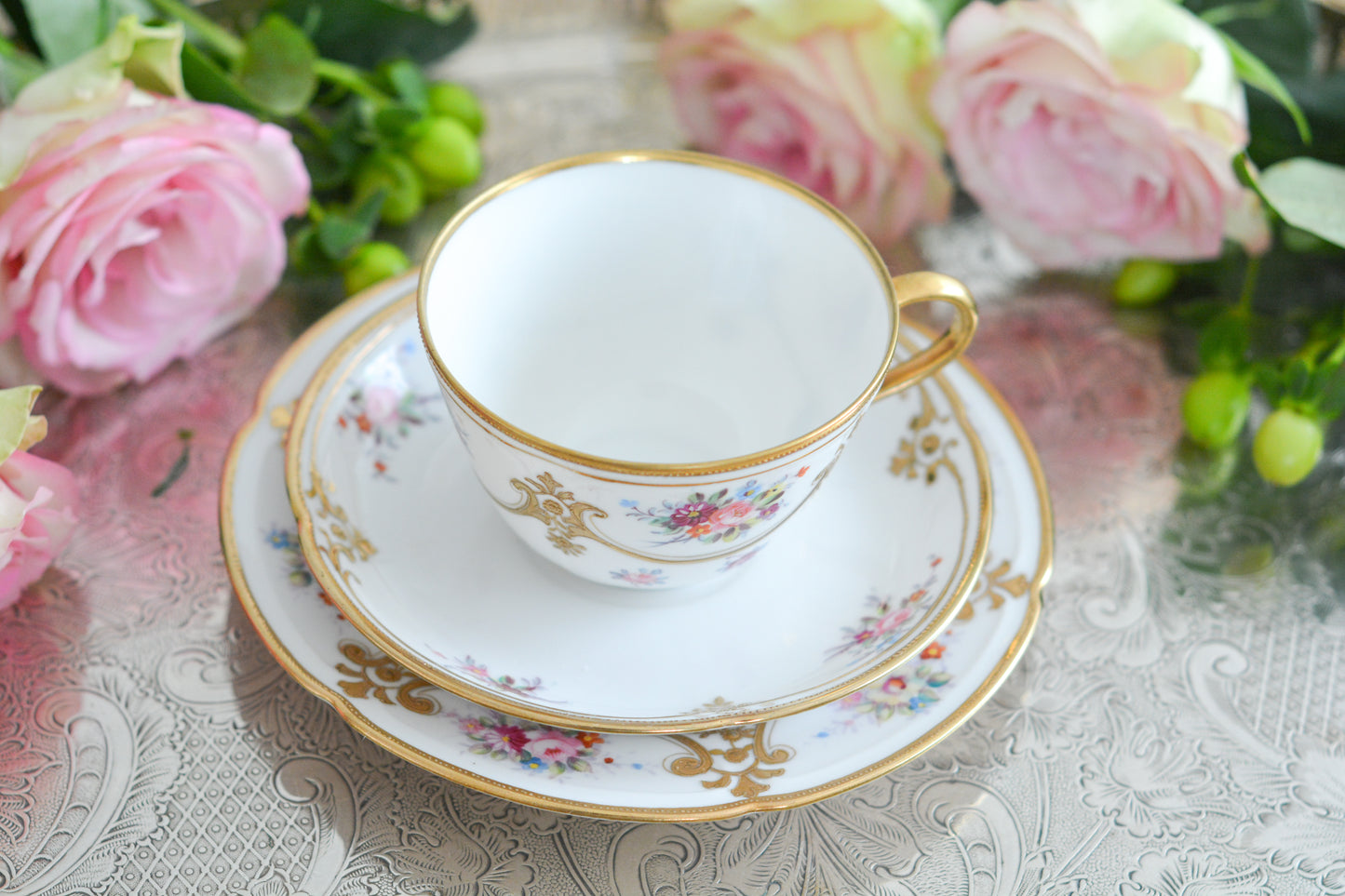 ノリタケの里帰り品のティートリオ。ハンドペイントで描かれた可愛らしいお花に金盛りの金彩の模様もとてもエレガントです。白磁がとても白く美しく気品を感じるお品。クリスマスはもちろんティータイムを華やかに盛り上げてくれるでしょう。
