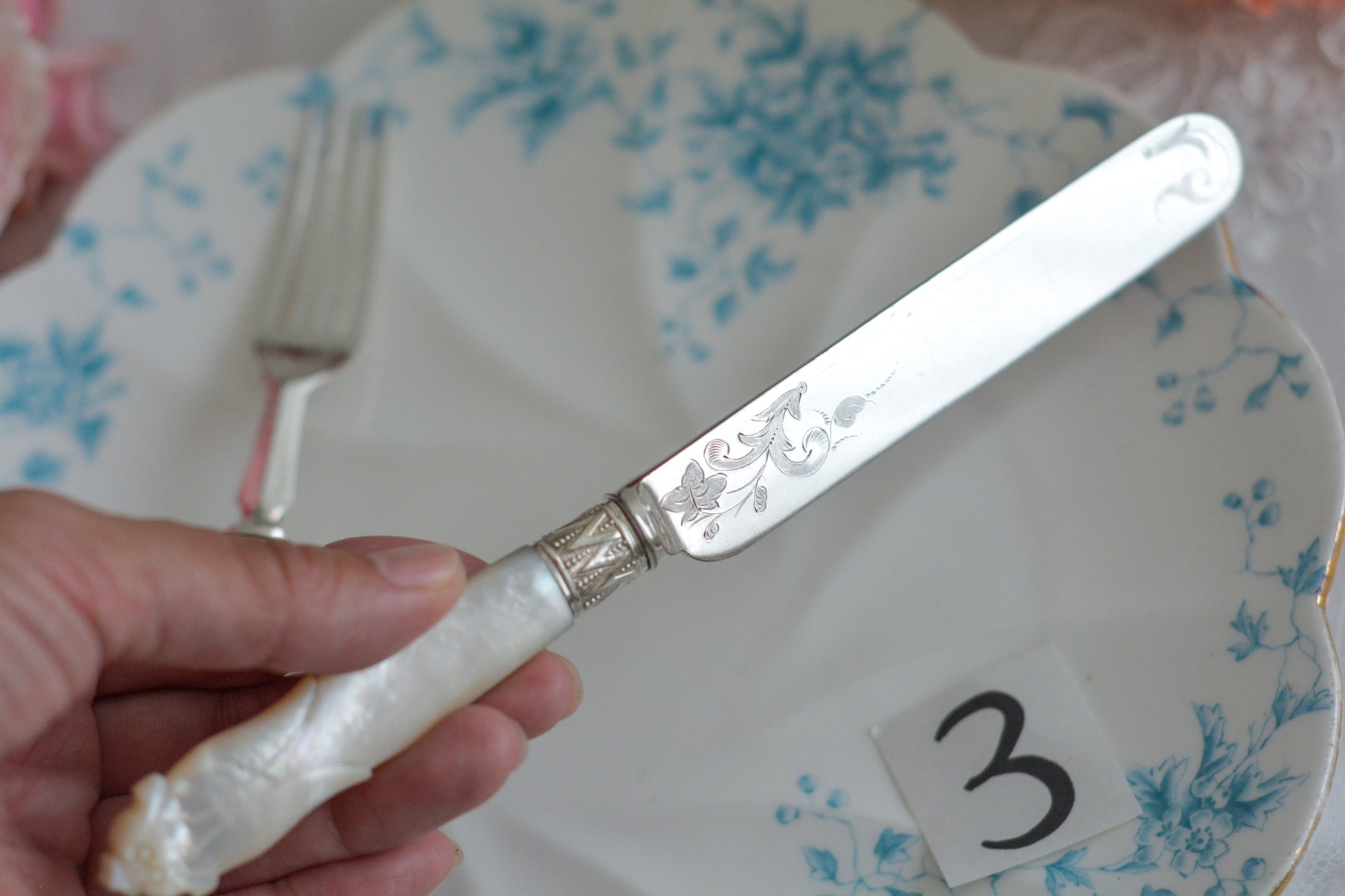 白蝶貝ハンドルと人気の丸刃のカトラリー。こちらは白蝶貝にも手彫りで模様が彫られています。シルバープレートのブレードに少しスレが見られます(状態を考慮した価格になっております)が、白蝶貝の優しい輝きと繊細な模様がとても美しいお品です。こちらは1組(フォークとナイフ2本セット)からご購入いただけます。①〜③からお選びください。