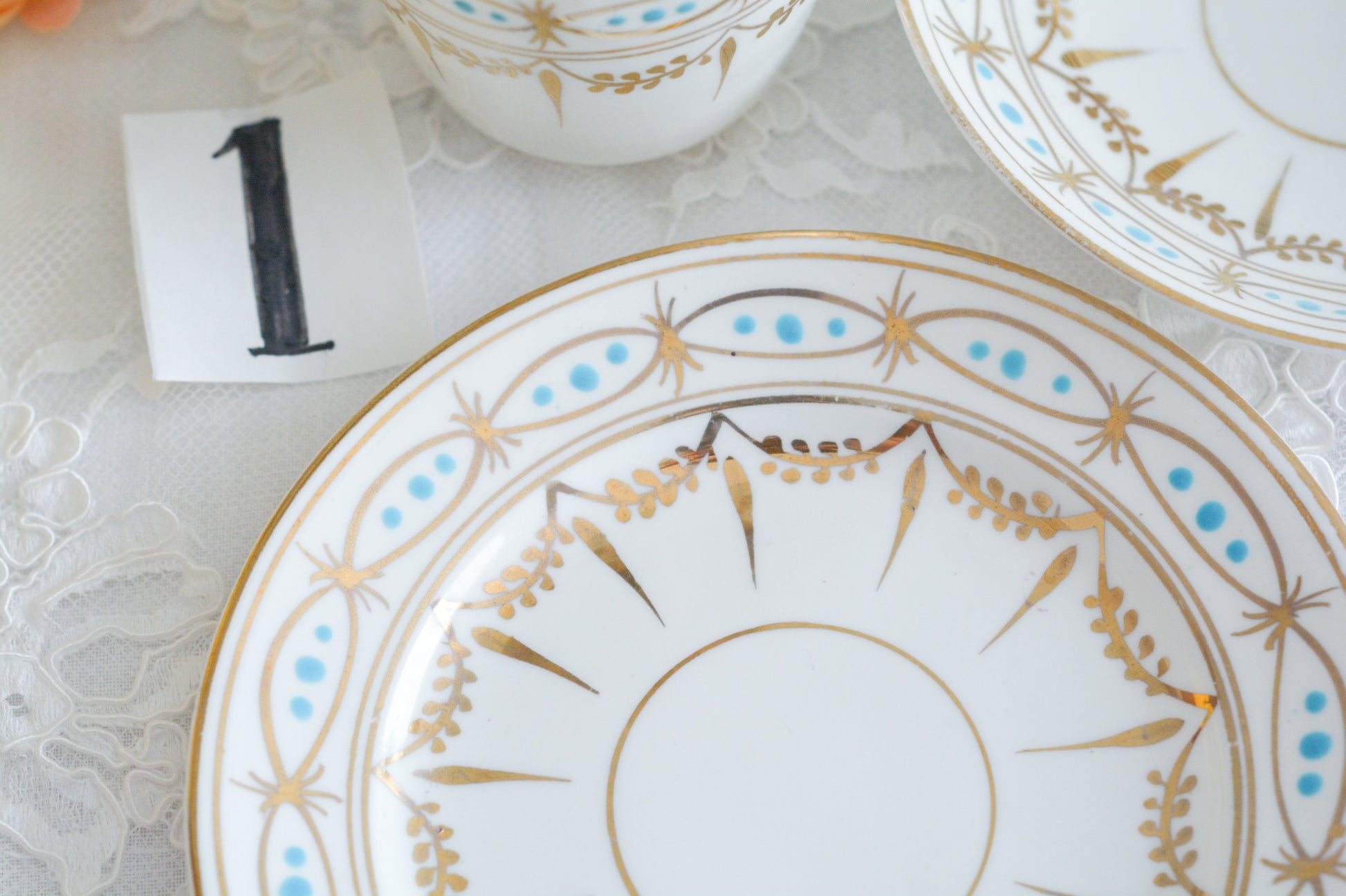 ハンドペイントで描かれた曲線美。アールヌーボースタイルのティートリオです。金彩にターコイズブルーのドットのコントラストが素敵なお品。カップは紅茶にもコーヒーにもお使いいただきやすいデザインです。