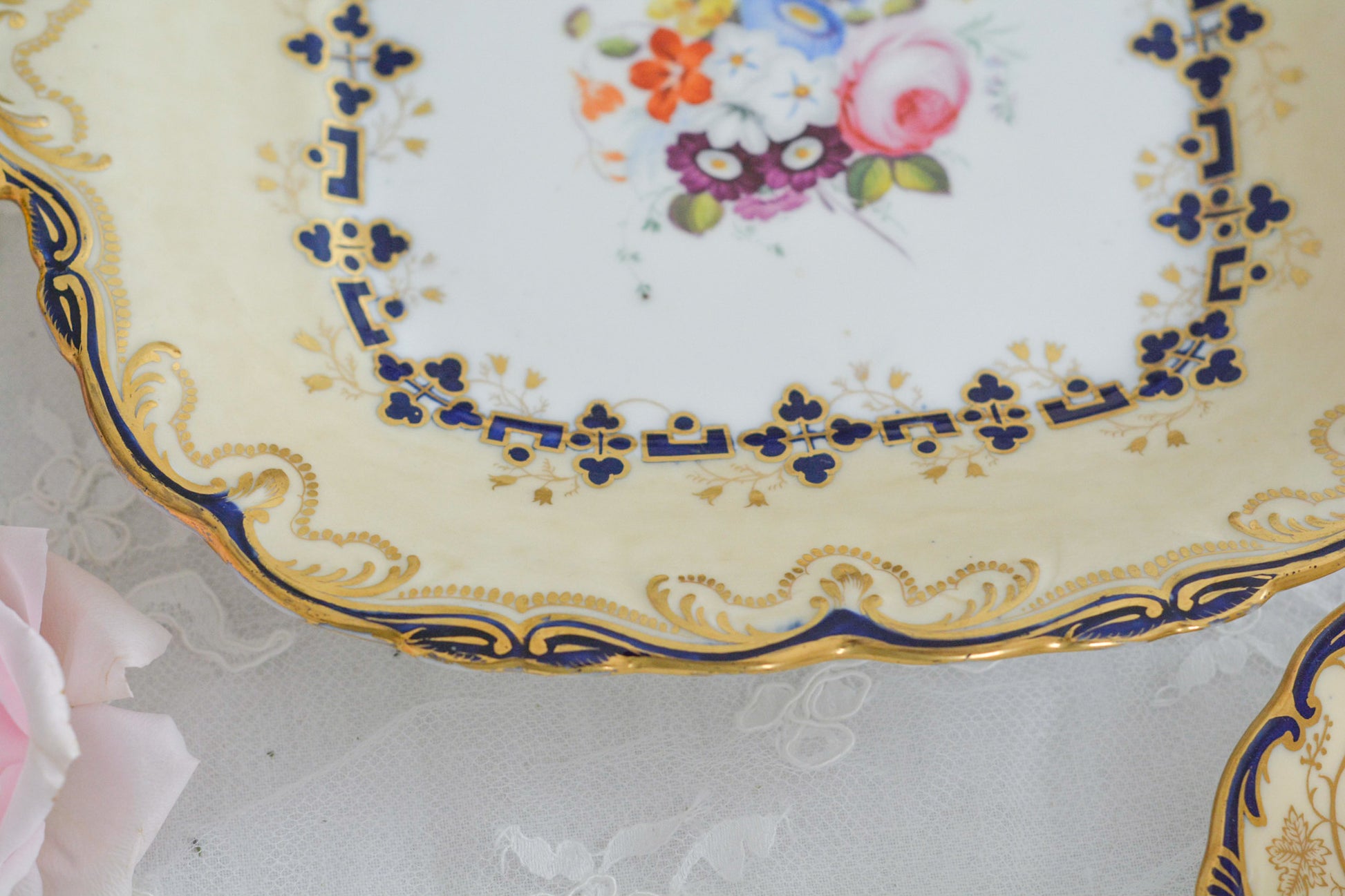 コールポートのアデレードシェイプのB&Bプレートです。ロココリバイバルの優雅なデザインが美しいです。ハンドペイントで描かれたブーケも大きく存在感もあり、ブーケを囲むコバルトブルーの模様もとっても可愛らしく、ブーケを引き立てています。B&Bとはブレッド&バターのことで、パンをもりつけたり、焼き菓子やフルーツなど様々な用途にお使いいただけます。テーブルがパッと華やかになるプレートです。